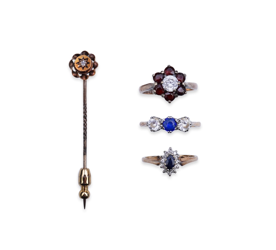 A group of three rings and a tie pin